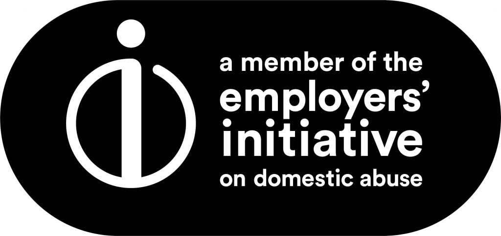 Logo for 'Employers' Initiative on Domestic Abuse' featuring a stylized "i" on the left and the text "a member of the employers' initiative on domestic abuse" on the right, emphasizing wellbeing and safety.