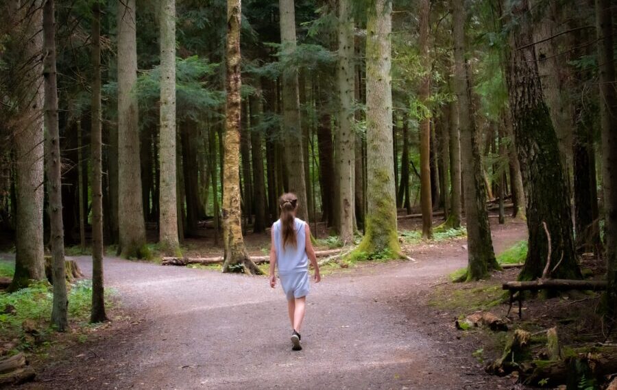 girl walking near trees