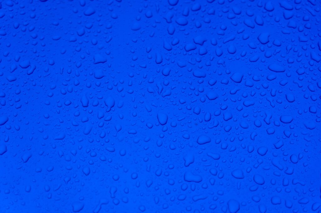 water droplets on blue surface