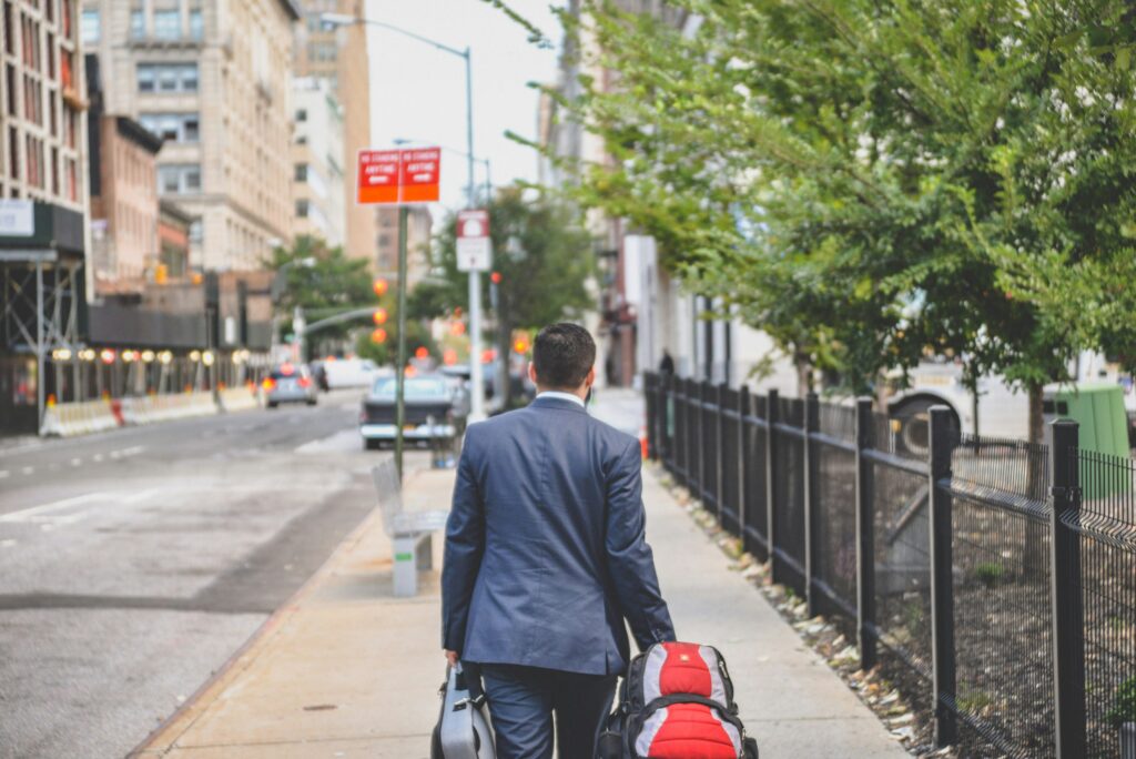 Man walking down road with bag