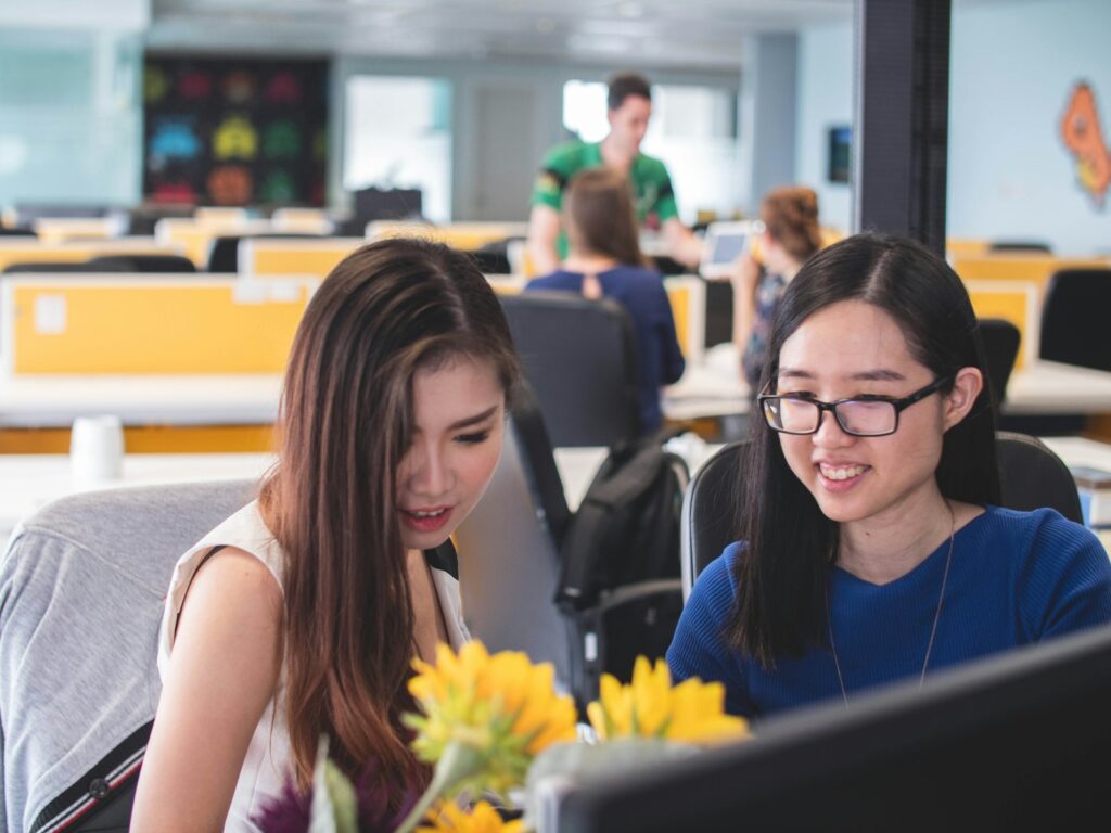 Two smiling women in an office.