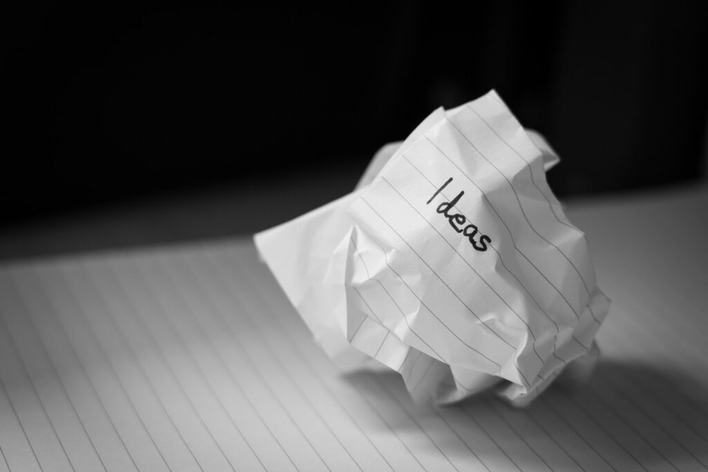 A piece of rolled up paper with "ideas" written on it.