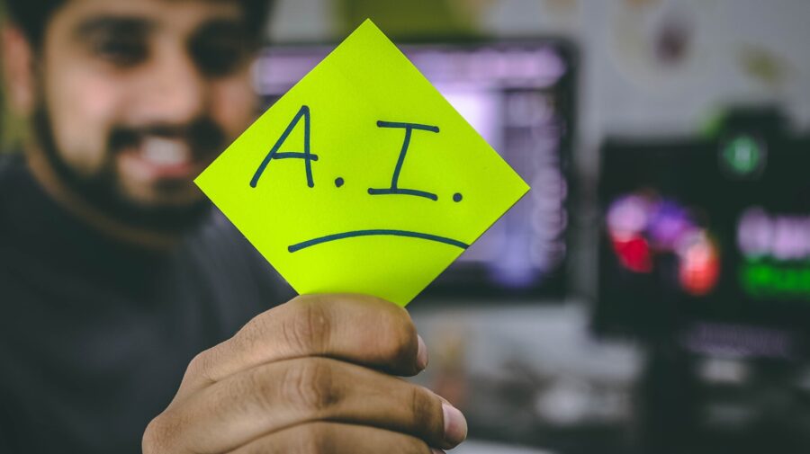 A person holding green paper saying AI.