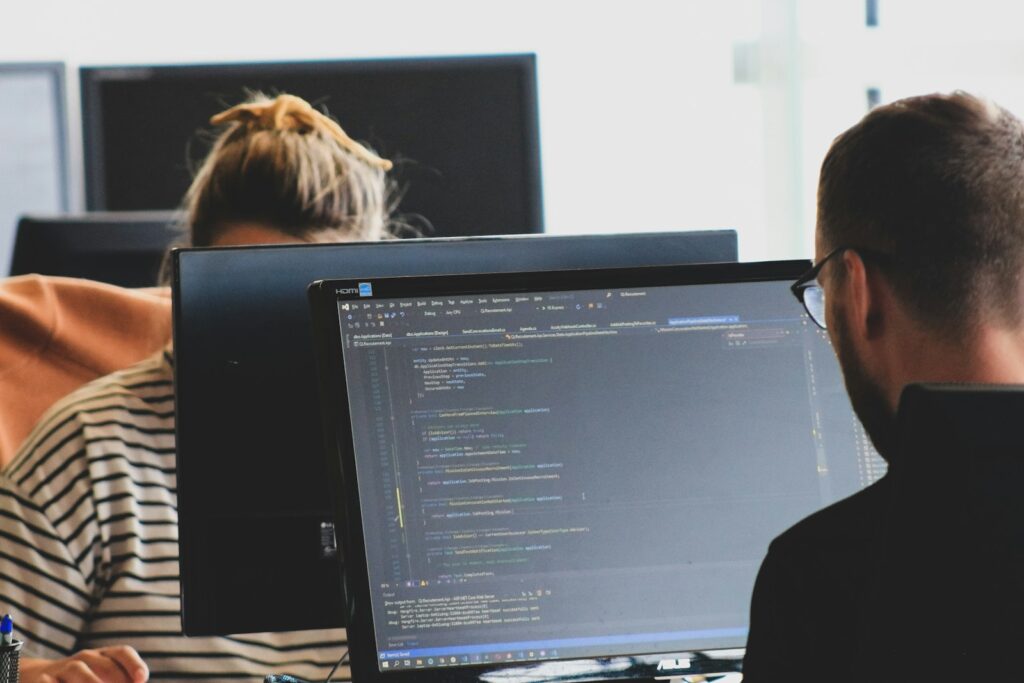 People working on computers in an office setting.