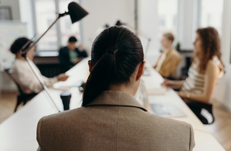 Diverse professionals collaborating in a modern office space, focused on teamwork and project management.
