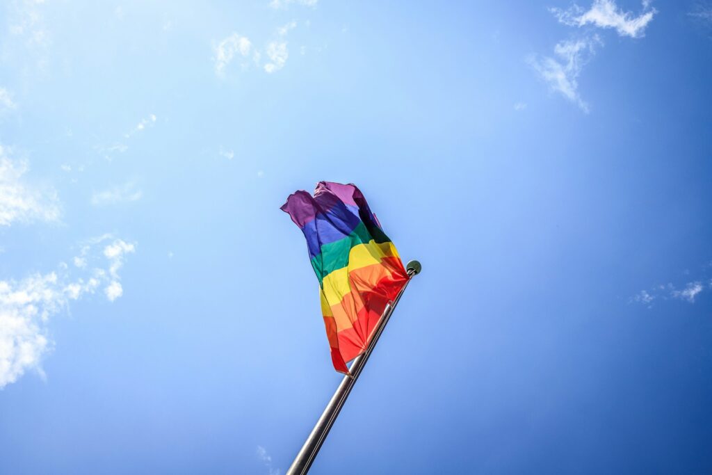 A pride flag blows in the wind.