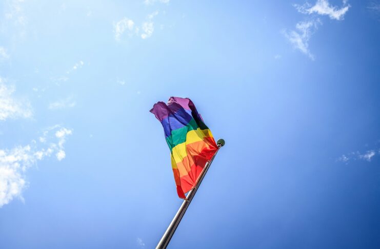 A pride flag blows in the wind.