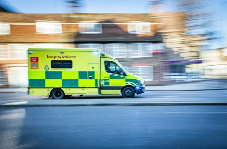 An ambulance races down a street.