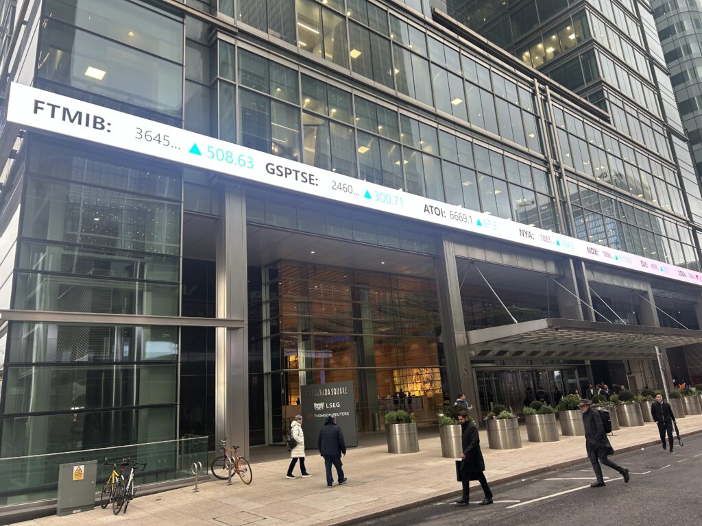 Workers walking on a street in London's financial district.