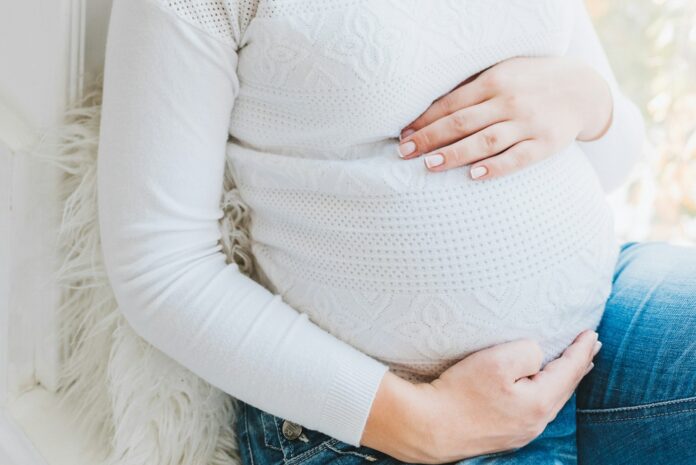 A close up of a pregnant woman.