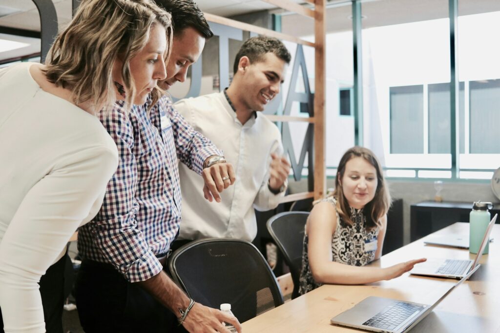 Office workers looking at a computer.