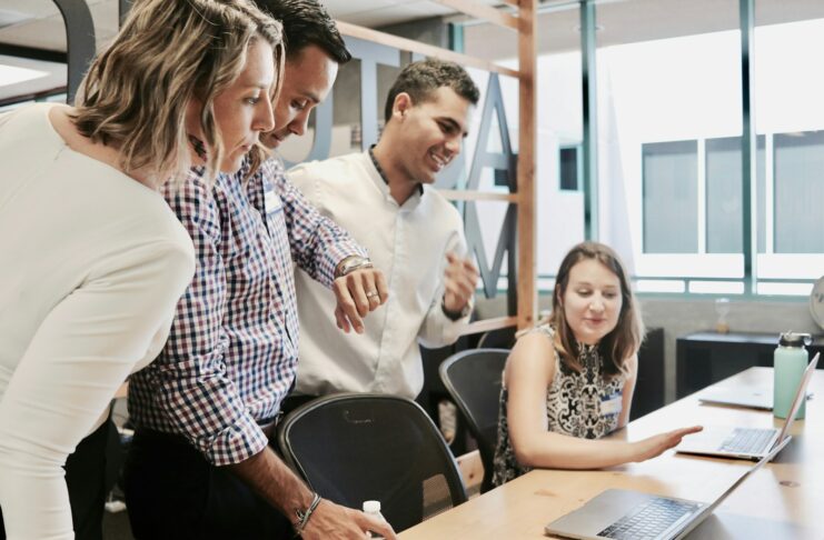 Office workers looking at a computer.