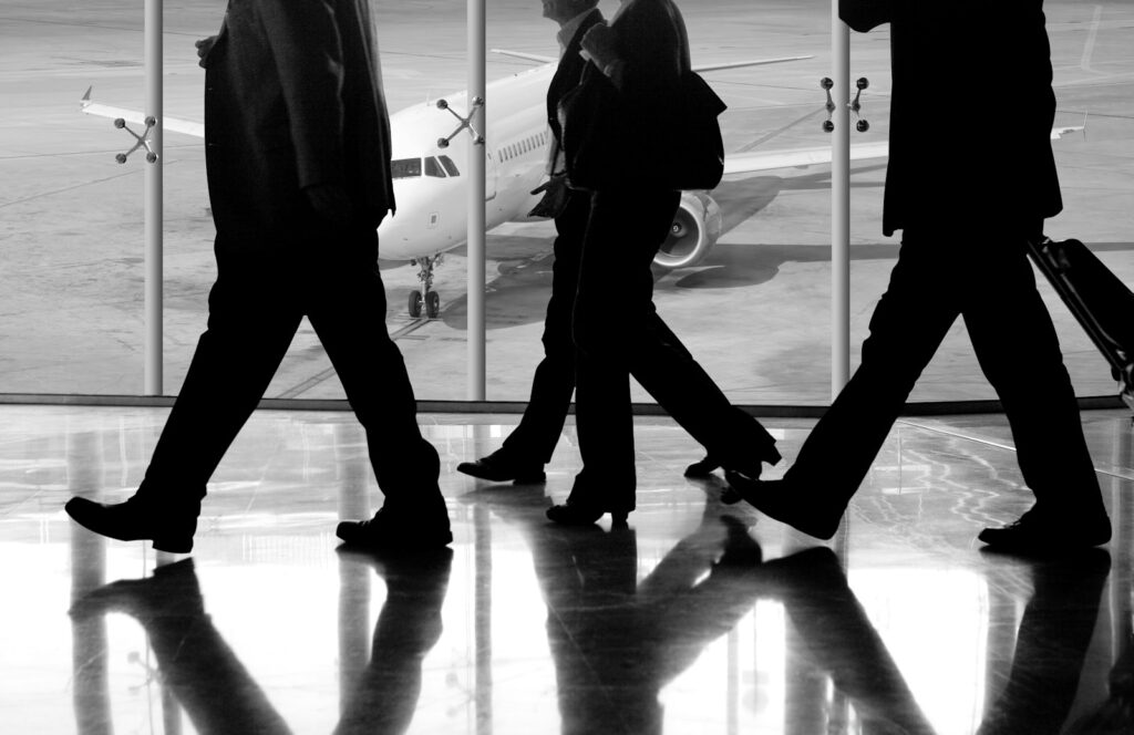 Businesspeople walk in an airport.