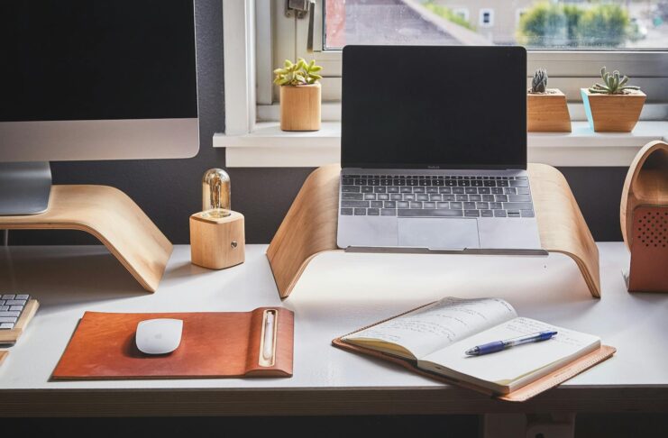A stylish and contemporary home office setup with laptop and desk accessories.