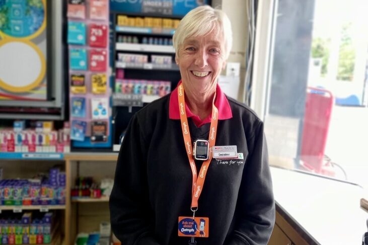 A female shop worker wearing a bodycam.