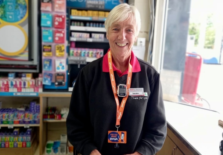 A female shop worker wearing a bodycam.