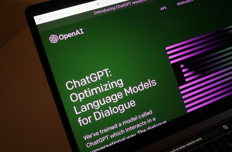 A laptop displays a webpage of OpenAI, creator of ChatGPT.