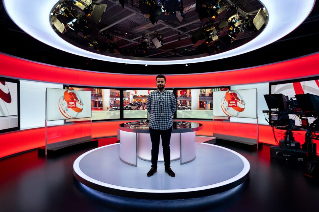 A person standing in a BBC News studio.