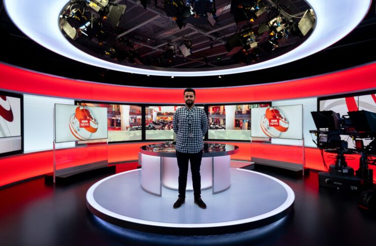 A person standing in a BBC News studio.