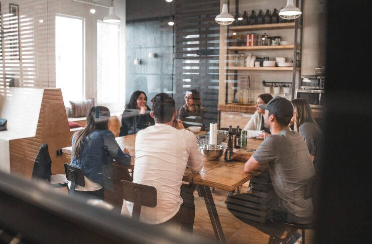 People gathered around a table in an office setting.