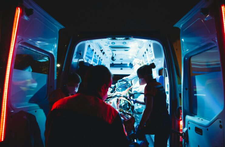 An injured person being taken out of an ambulance.
