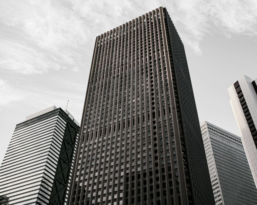 Four skyscrapers against a cloudy sky.