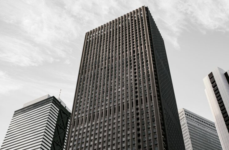 Four skyscrapers against a cloudy sky.