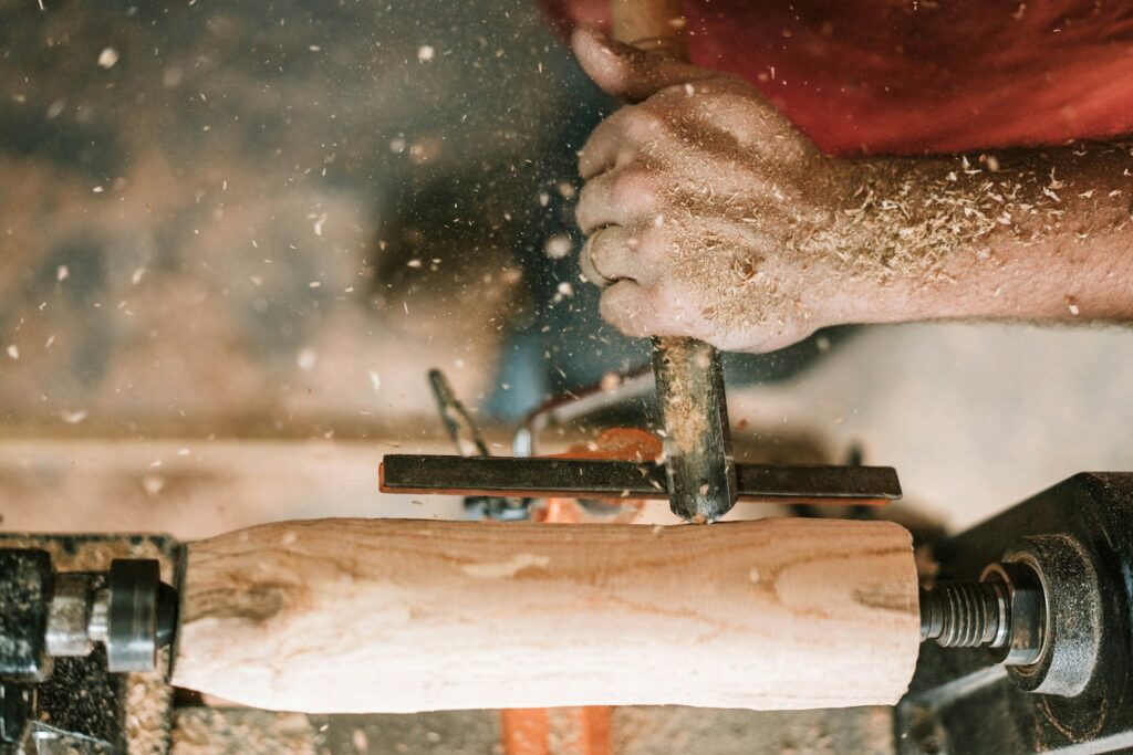 A carpenter working on a piece of wood.