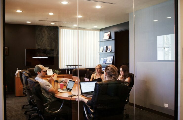People having a meeting around a table in an office.