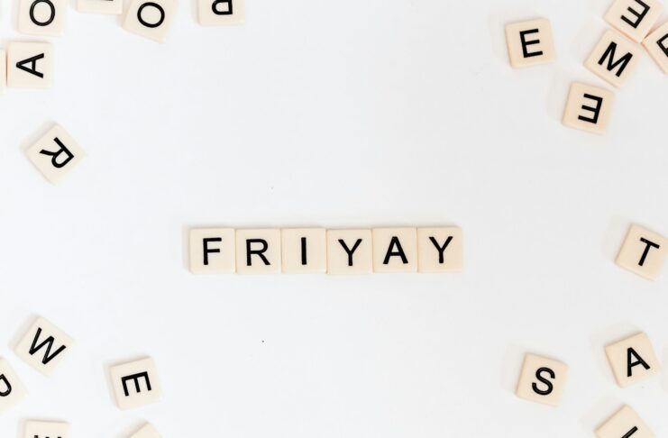 Friyay scrabble pieces on a white surface.