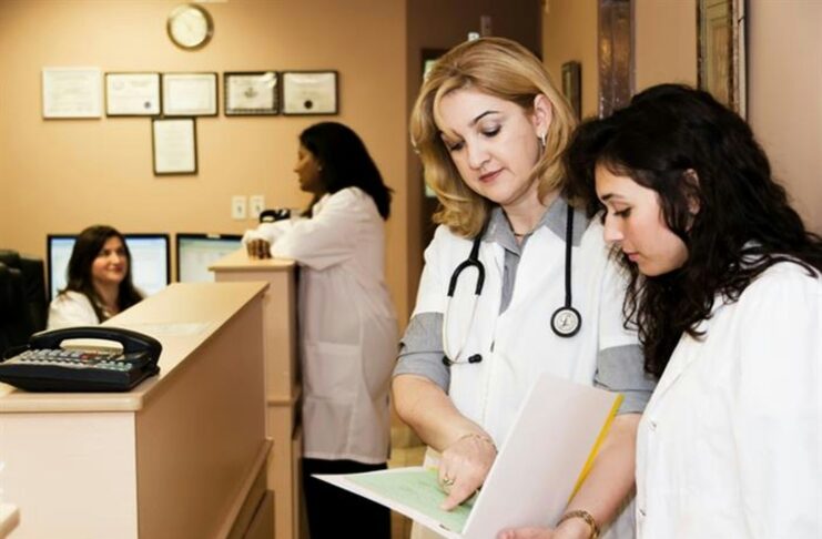 Medical professionals talking in a clinical setting.