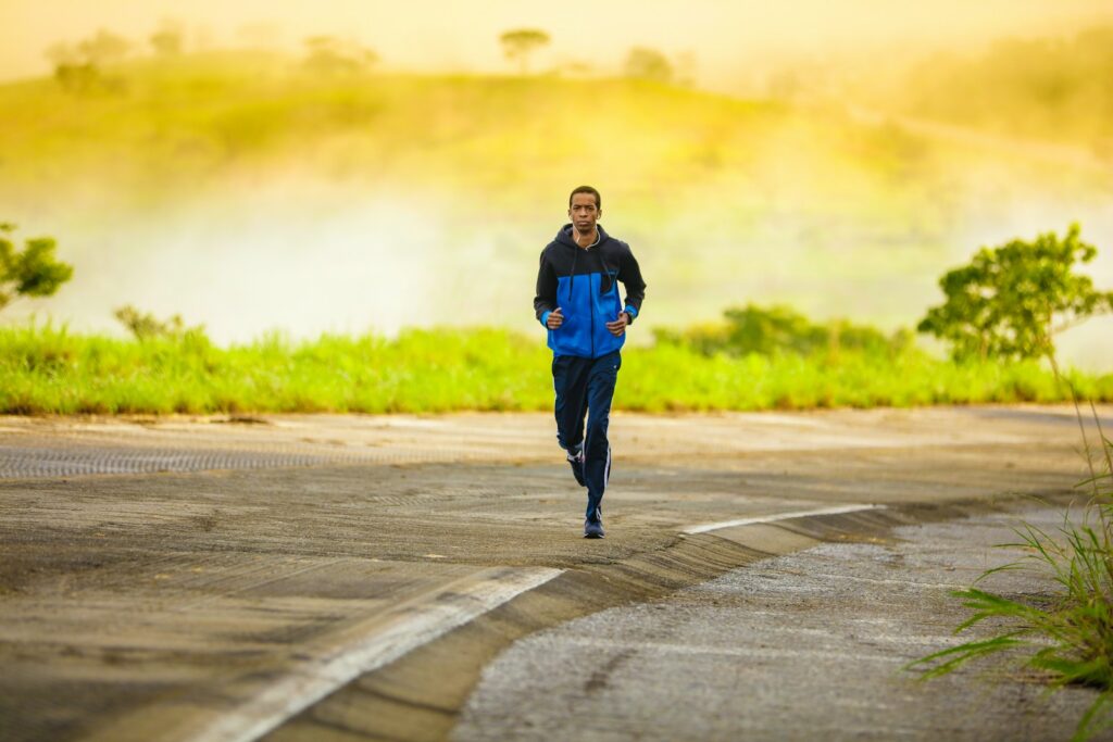 A man jogging along a road.