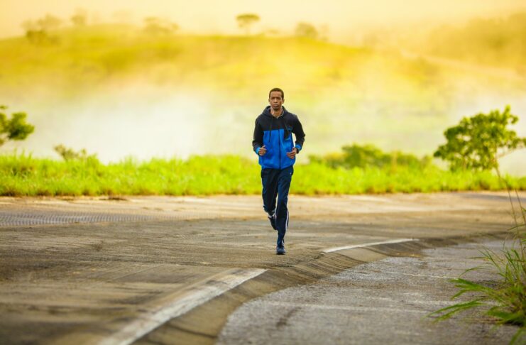 A man jogging along a road.
