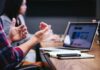 Over 40% of Companies ‘Lack Formal Health and Wellbeing Strategy’ People at a work desk with a laptop.