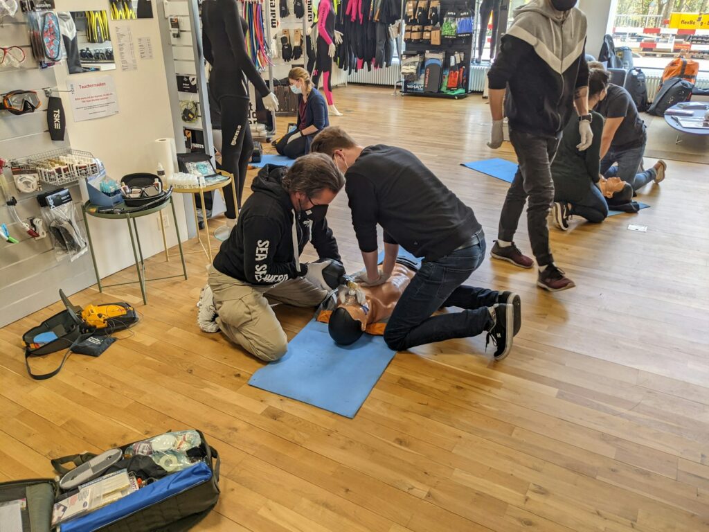 People practicising first aid by doing CPR.