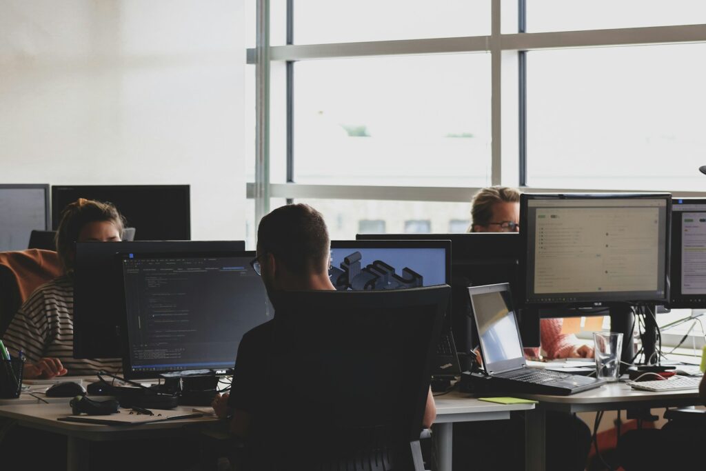 Workers at computers in an open office setting.