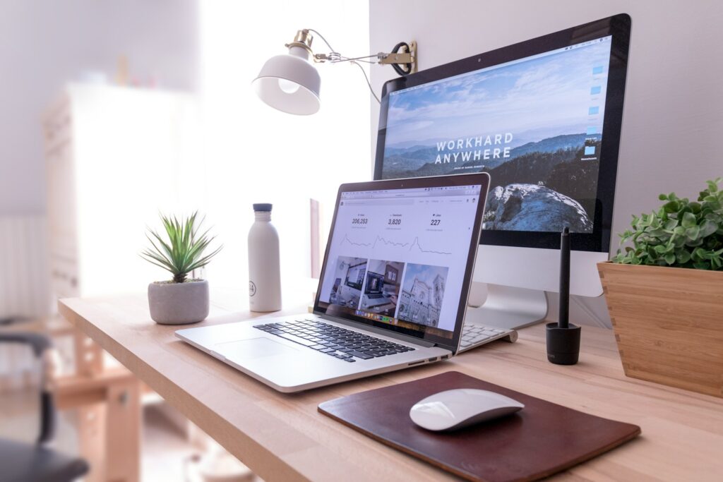 Computers at a desk in a home office setup.