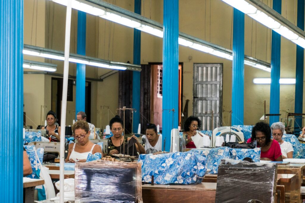 Women working at sewing machines in a clothing factory.