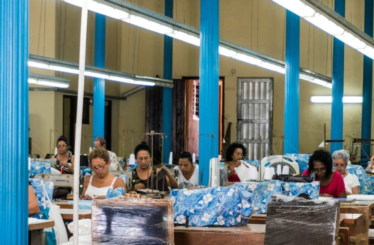 Women working at sewing machines in a clothing factory.