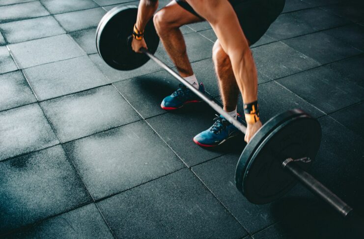 A person doing deadlifts.