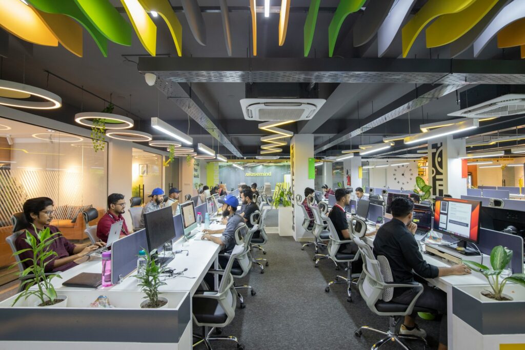 People sitting at desks in a large open-plan office.