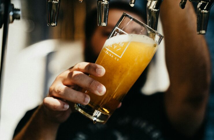 A man pouring a pint of beer.