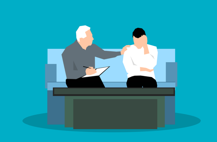 A man talking to another, who appears to be disengaged.