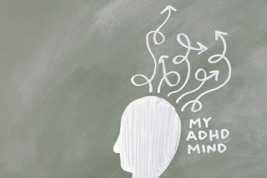 Creative depiction of the ADHD mind with chalk arrows on a grey board.