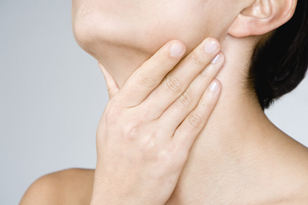 Woman touching her neck.