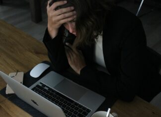 Managers ‘Lack Confidence on Neurodiversity’ as Tribunal Cases Reach Five Year High A woman working at a laptop while looking stressed.