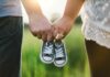 Calls for Legal Right to Paid Leave for Fertility Treatment woman and man holding black crib shoes standing near green grass during daytime