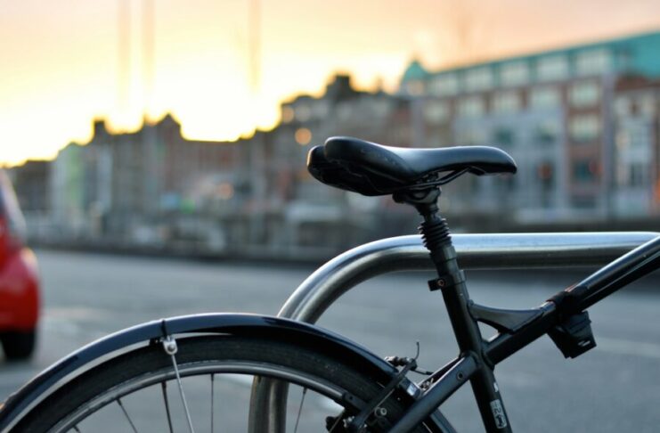 black mountain bike parked near the road