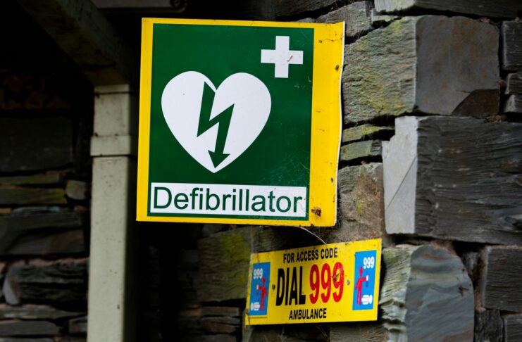 a green and yellow sign with a heart on it