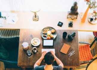 Work-Life Balance ‘Now Greater Source of Stress Than Finances’ A man works on a laptop in a home setting.